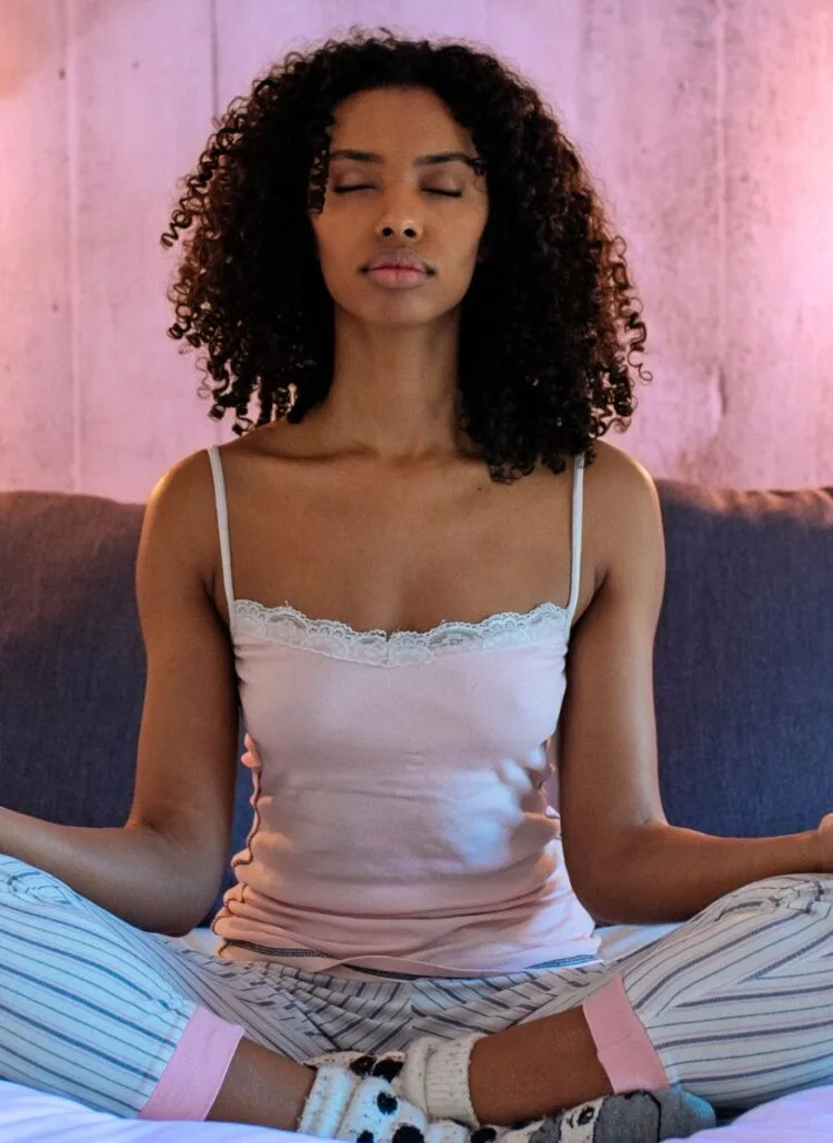 young black woman meditation in bedroom starting healthy habits