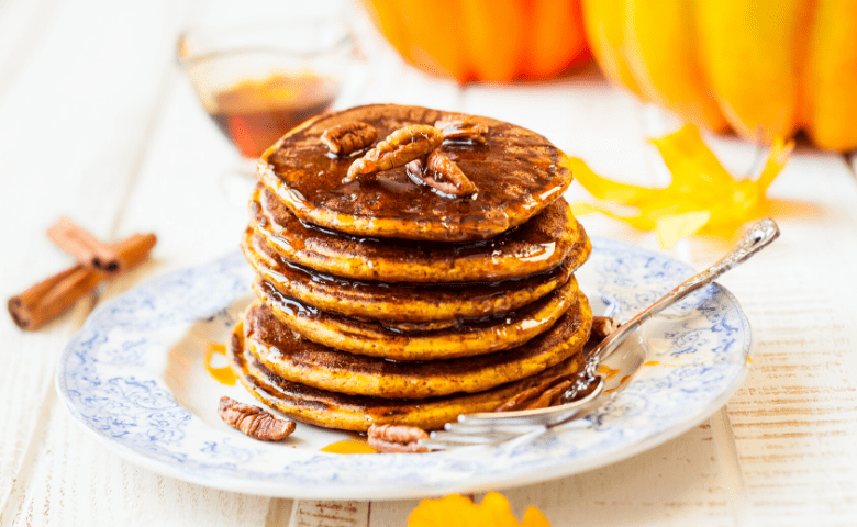 stack of five edible pumpkin spice pancakes infused with cannabis on white and blue plate