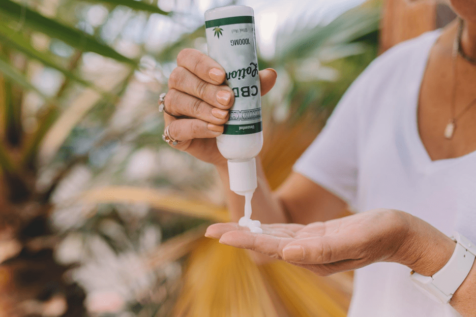 woman is pouring CBD lotion into her hand