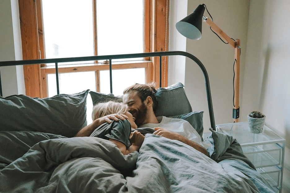 couple snuggling in bed after great orgasm due to cbd products enhancing sex life