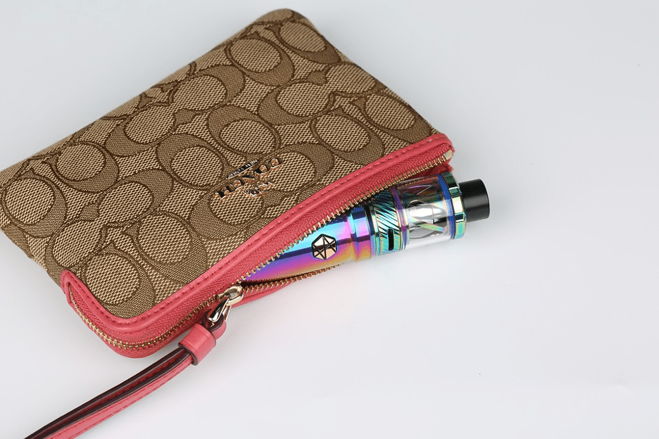 woman's coach wallet with a cool vape pen with rainbow skin