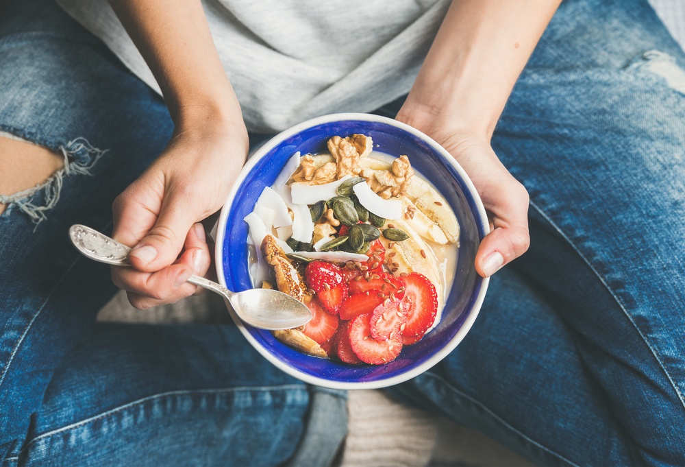 woman eating acai bowl to manage her ADHD