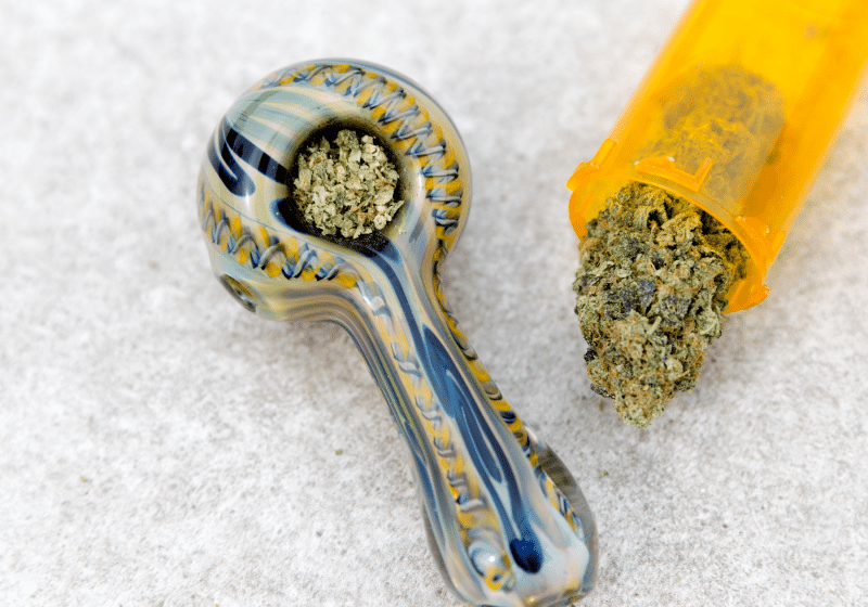 glass marijuana pipe and cannabis flower