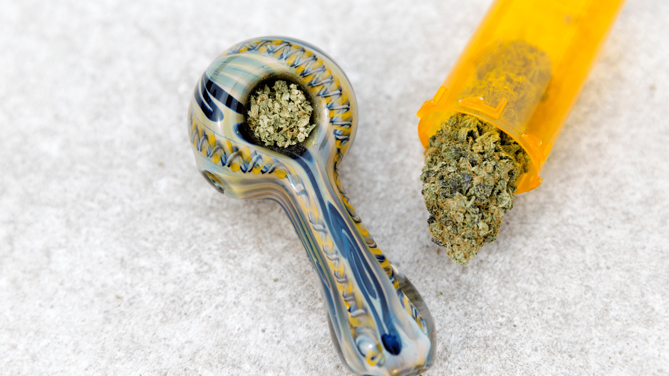 glass marijuana pipe and cannabis flower