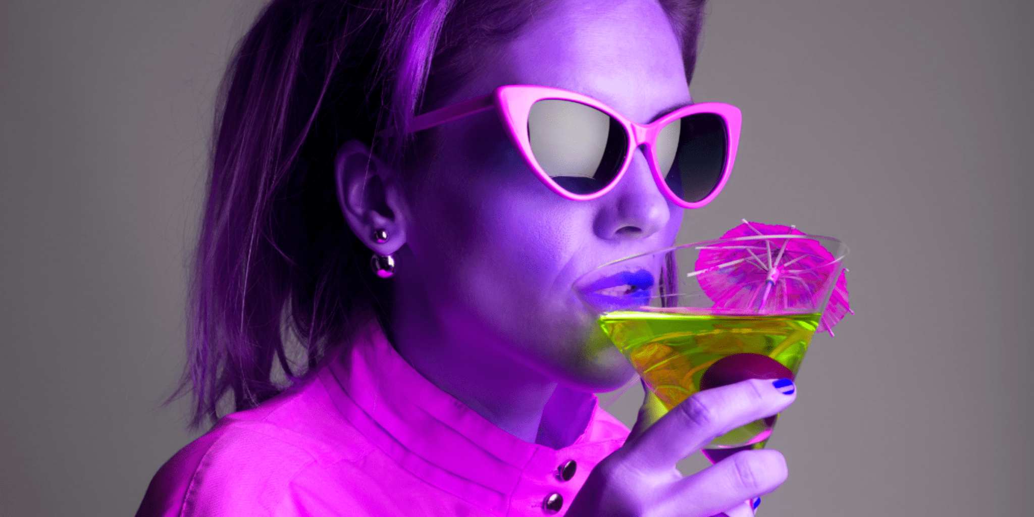 retro trippy woman with purple sunglasses sipping on cannabis infused cocktail