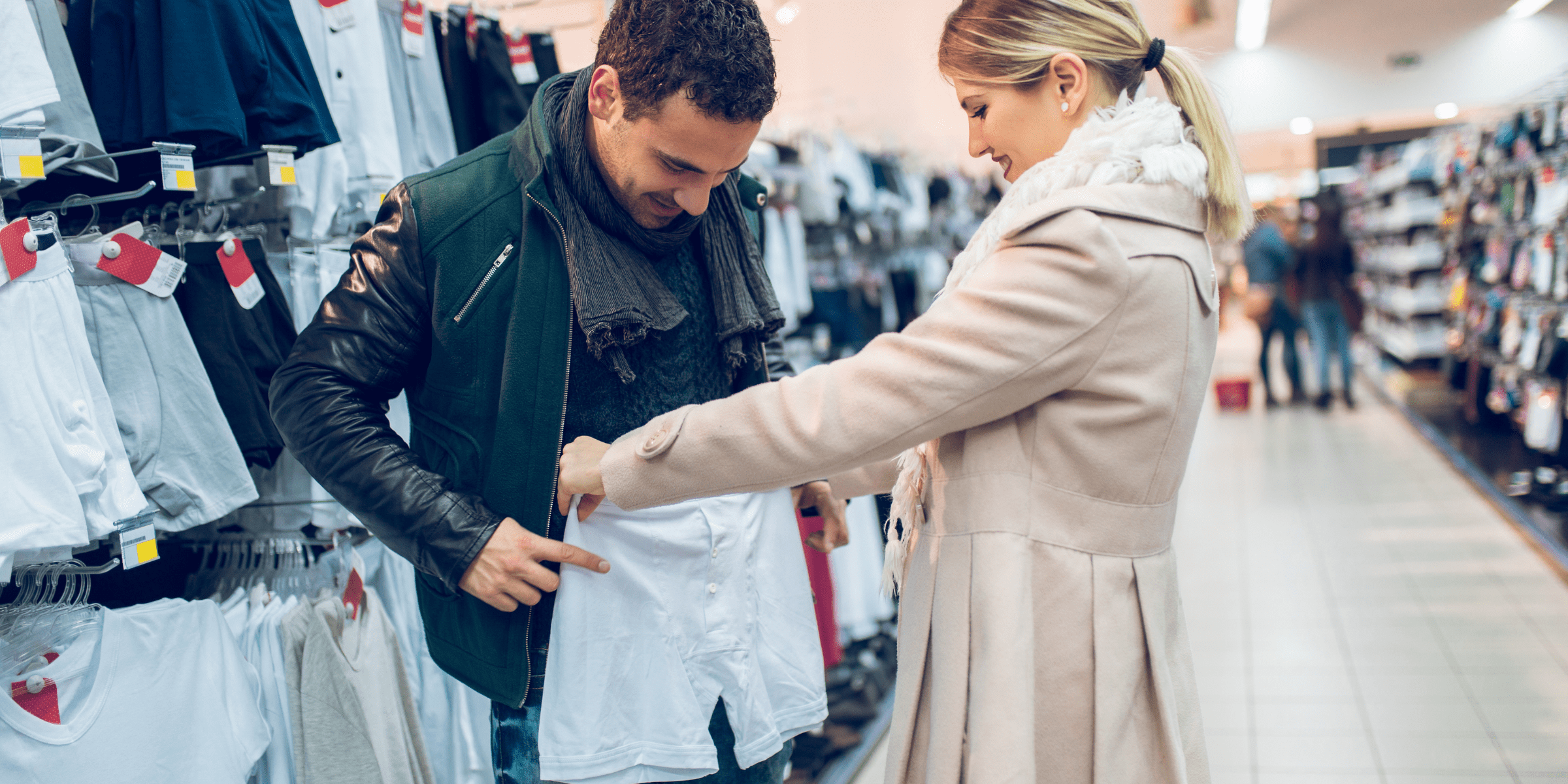 man trying on underwear in store with his wife