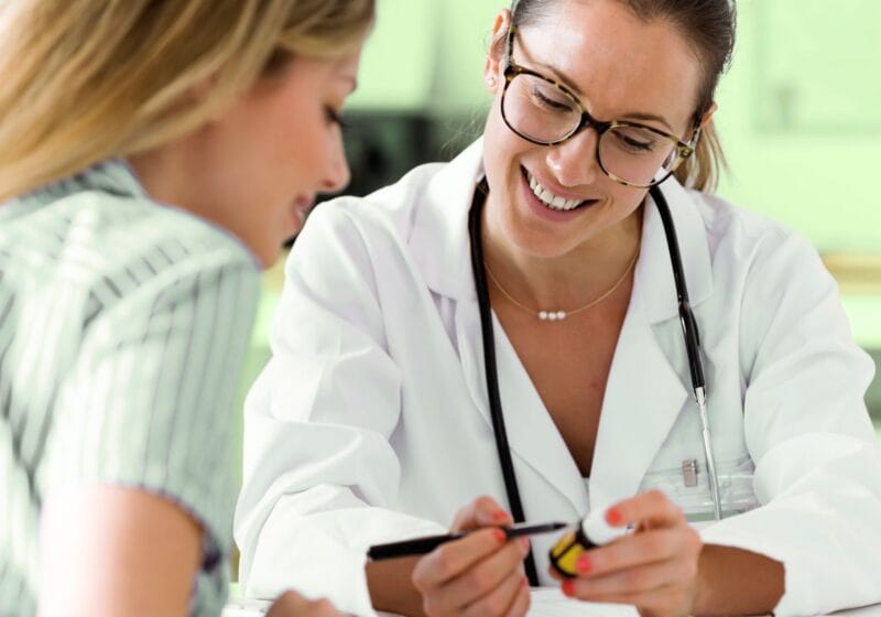 woman at her annual doctor checkup learning about a new medication