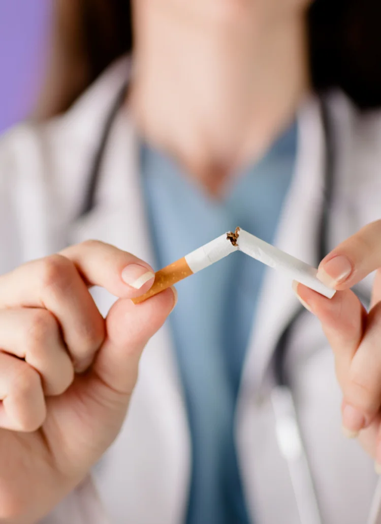 doctor breaking cigarette to help female patients quit smoking