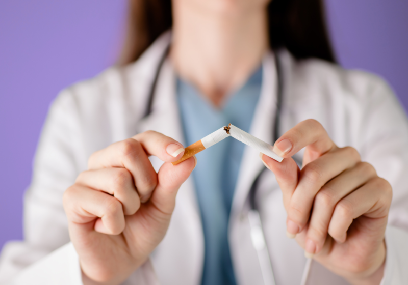 doctor breaking cigarette to help female patients quit smoking