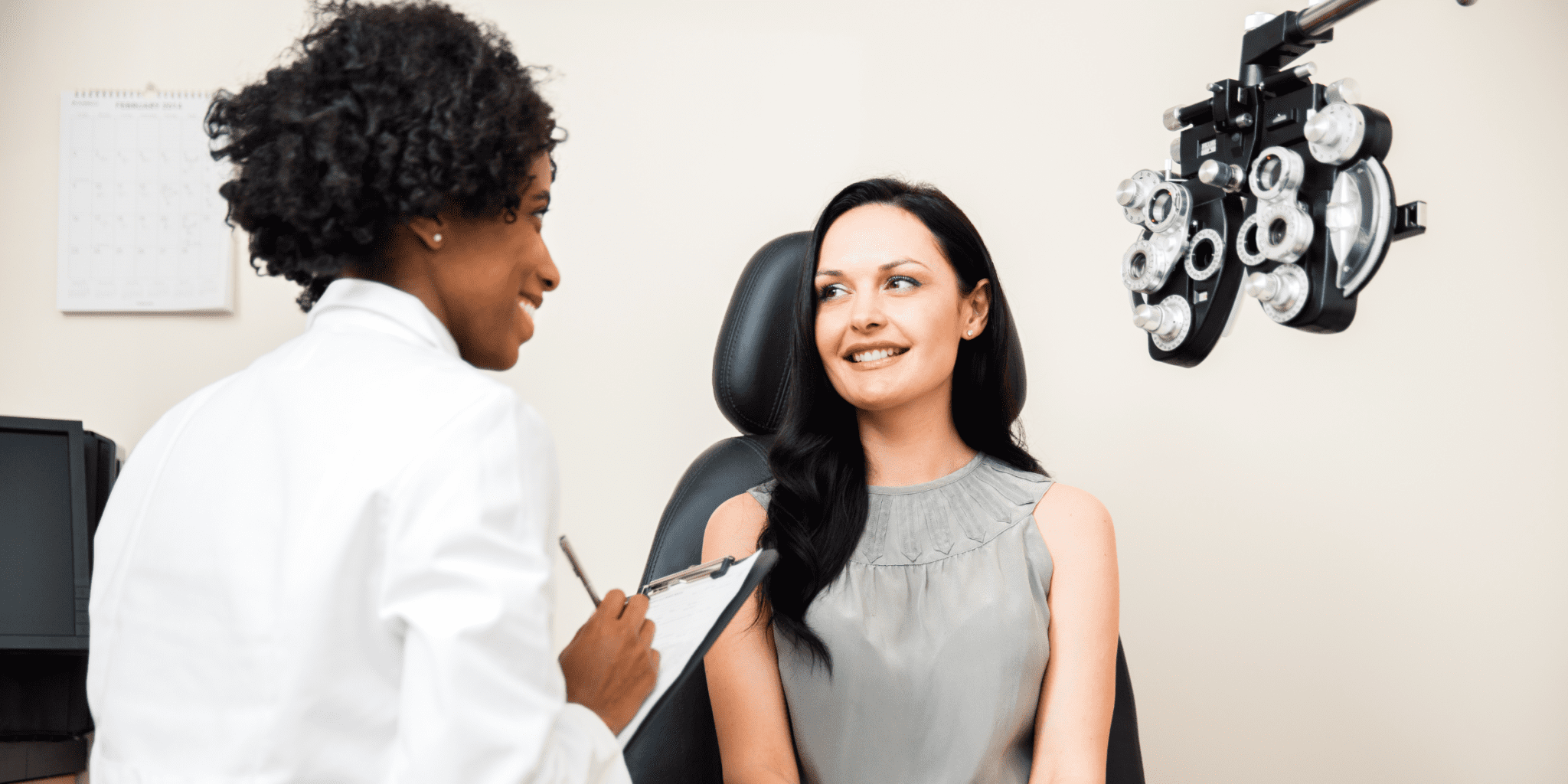 black eye doctor talk to female patient about vision in medical checkup