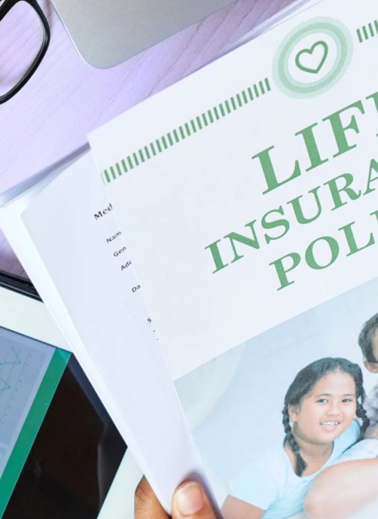 Woman looking at Life Insurance Policy Pamplet on desk