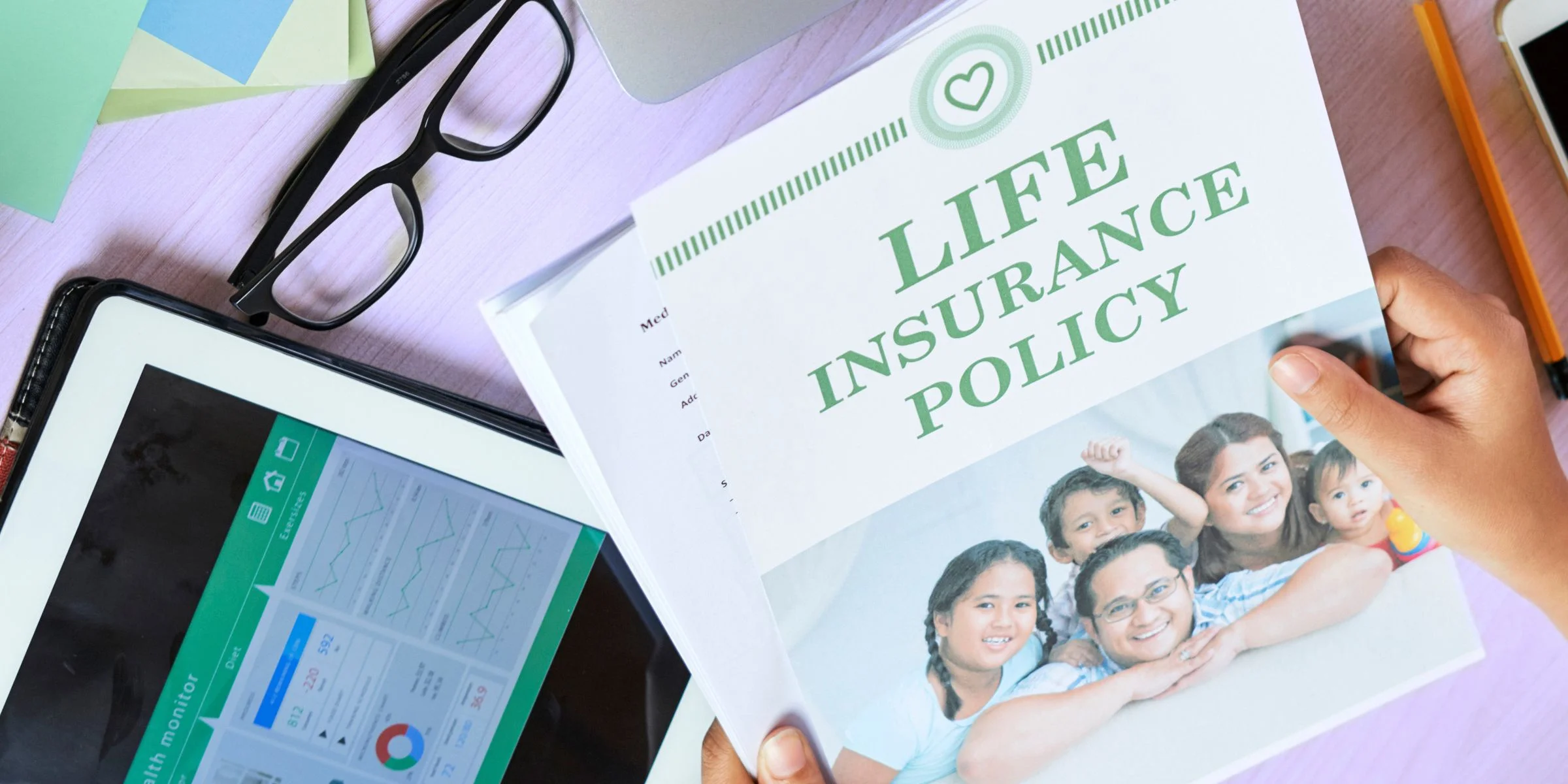 Woman looking at Life Insurance Policy Pamplet on desk