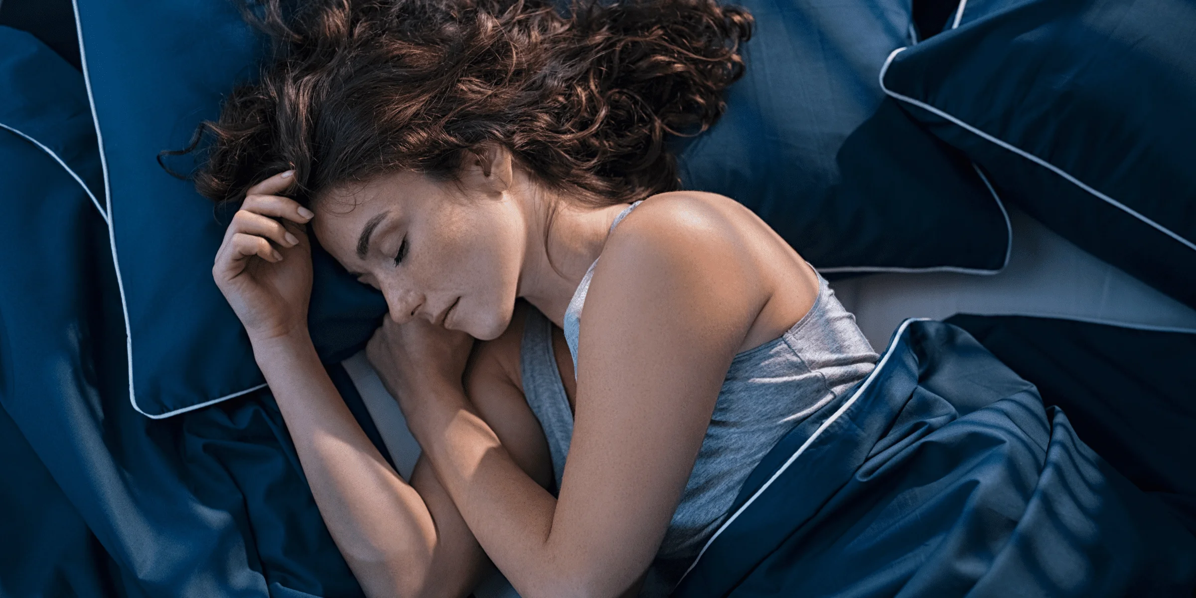 white woman sleeping in bed