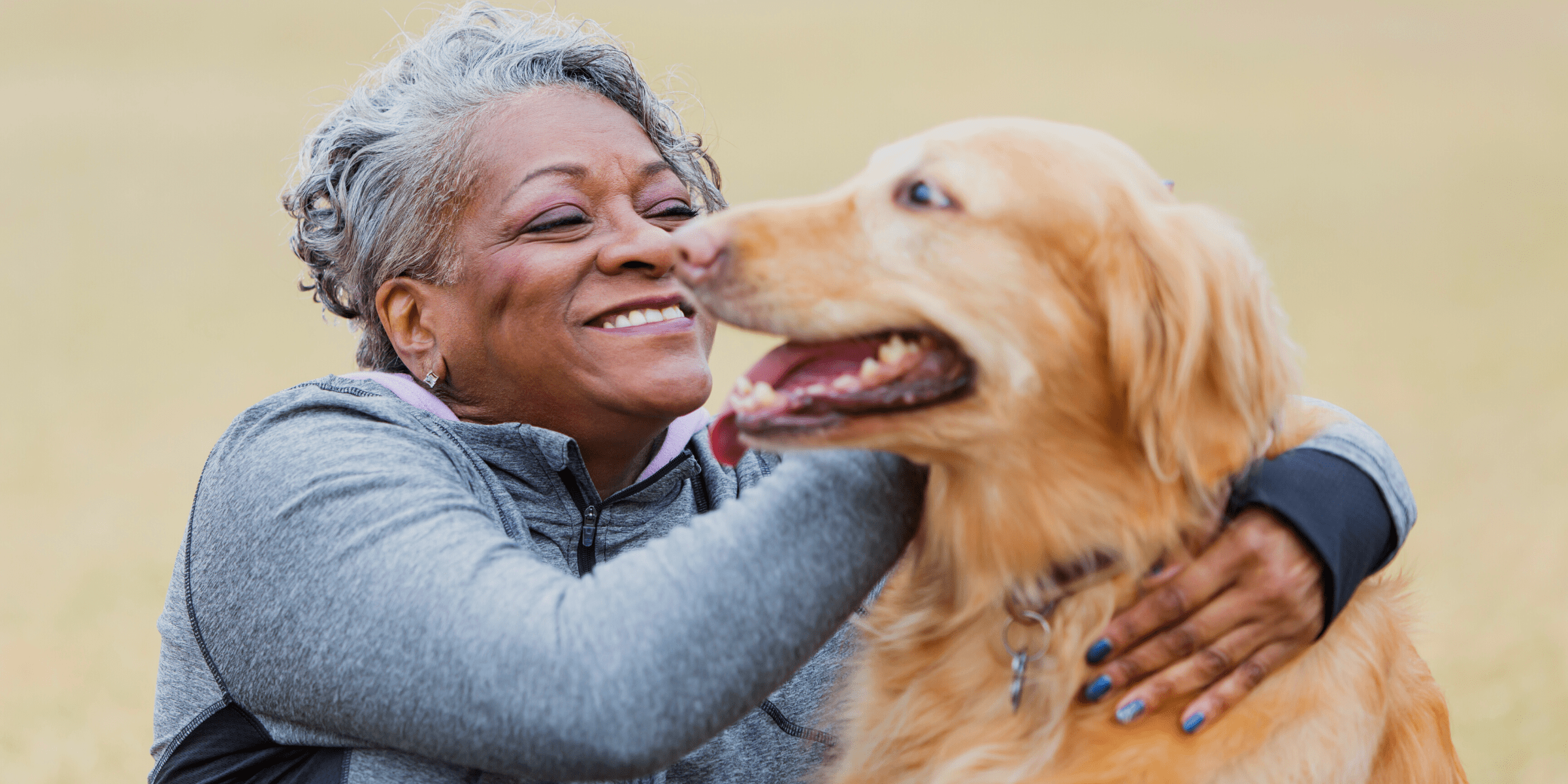 senior woman petting anxious dog that took hemp oil