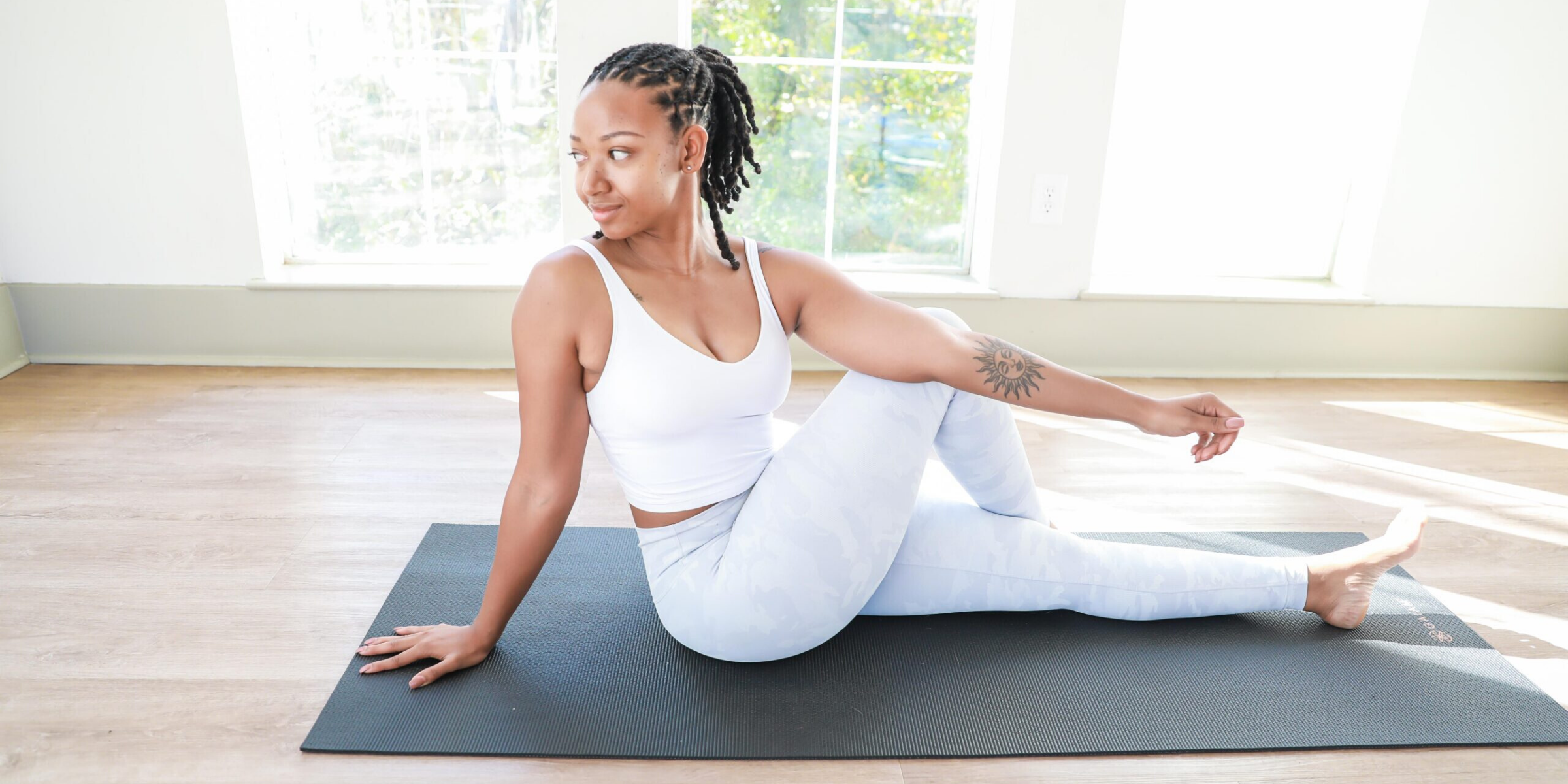young black woman doing yoga at home to stay fit
