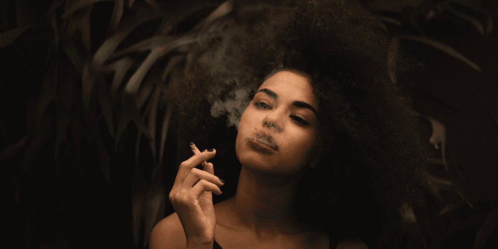 black woman smoking herbs joint