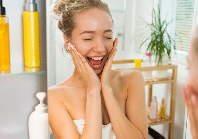 young woman is excited after applying cbd moisturizer to her face in the spa