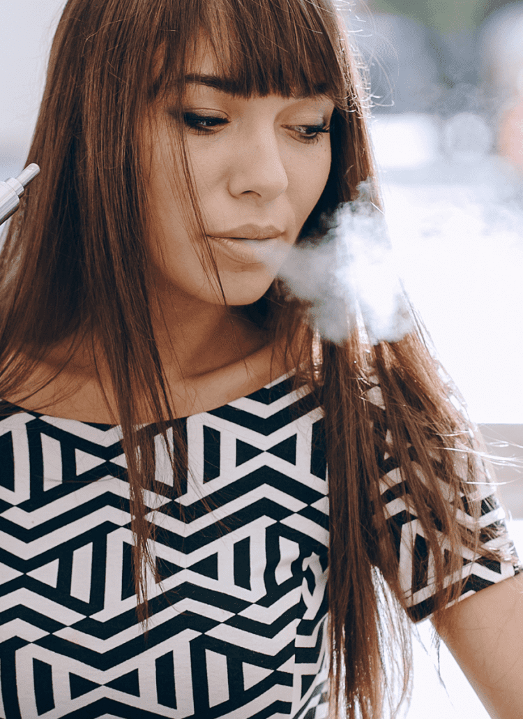 young woman vaping cbd cannabis
