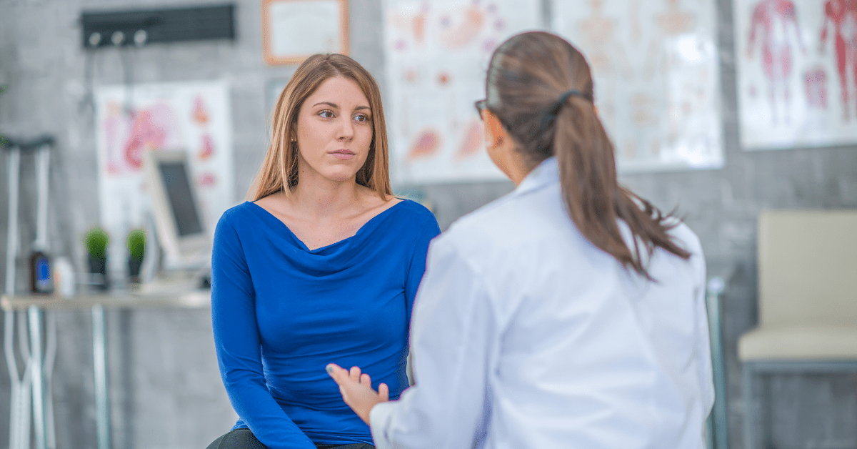 female doctor talking to woman patient