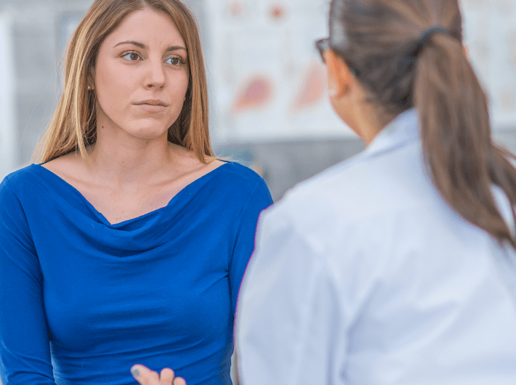 woman doctor talking to female patient about health