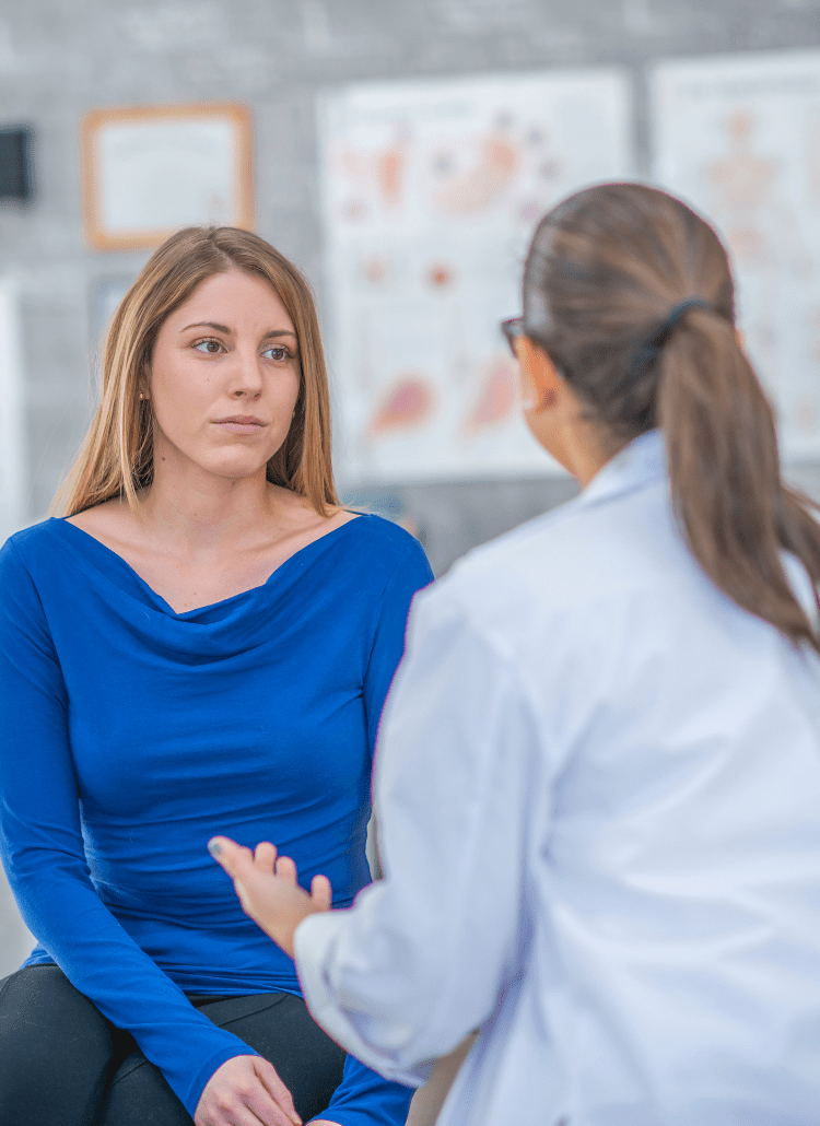 woman doctor talking to female patient about health