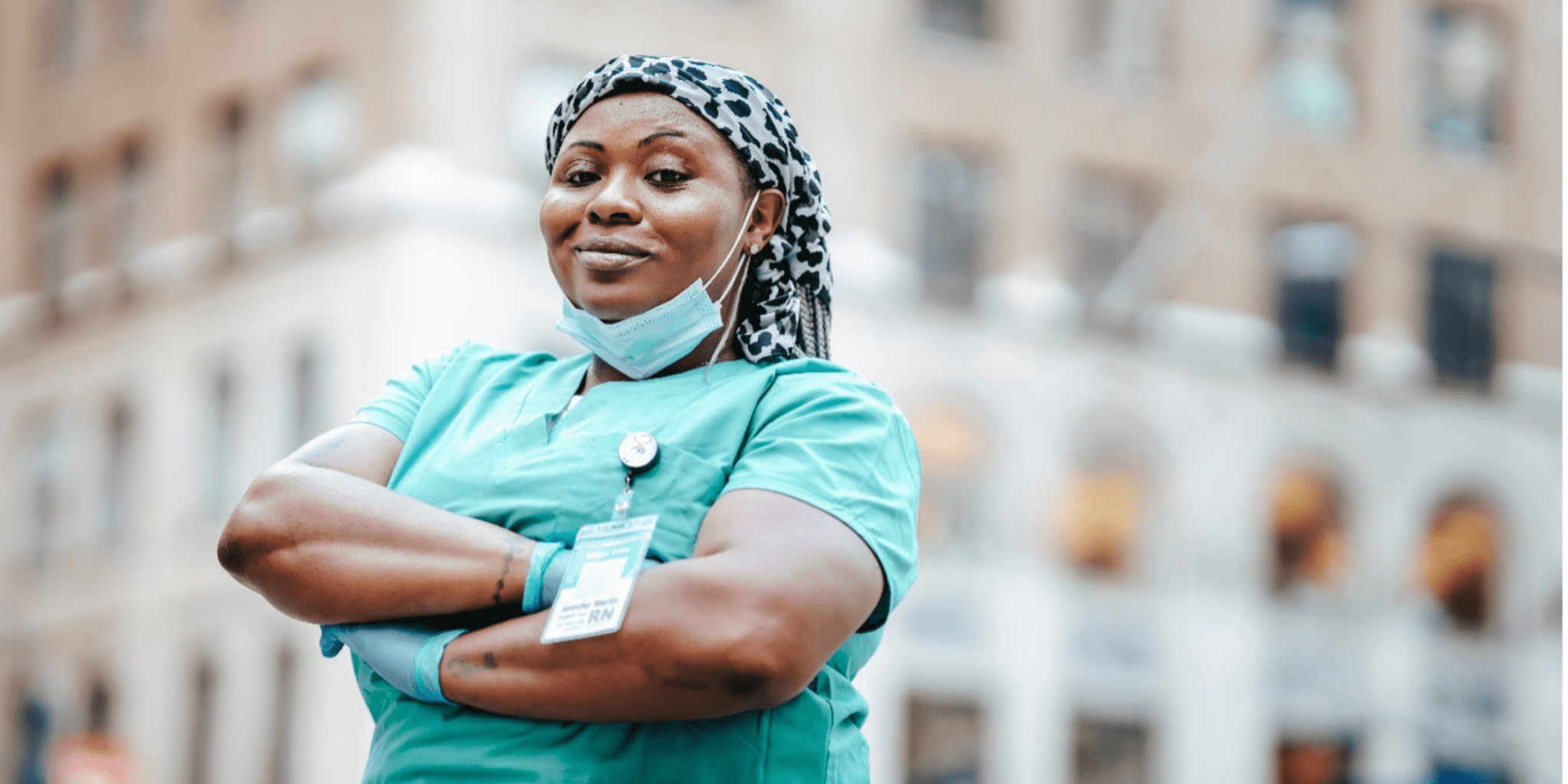 black woman chose nursing career standing in front of hospital where she works