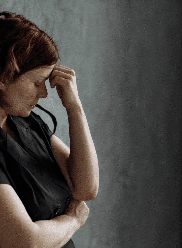 redheaded woman looks depressed over long-covid symptoms
