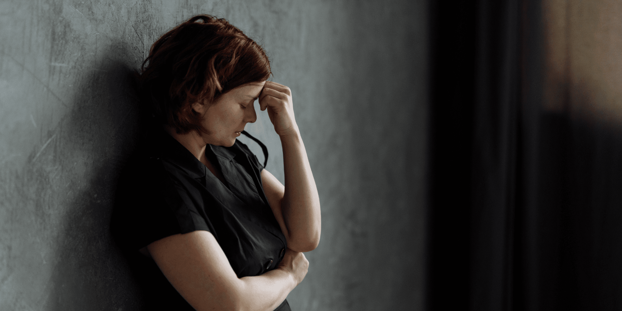 redheaded woman looks depressed over long-covid symptoms