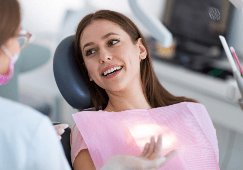 woman happy looking at her new smile at the dentist