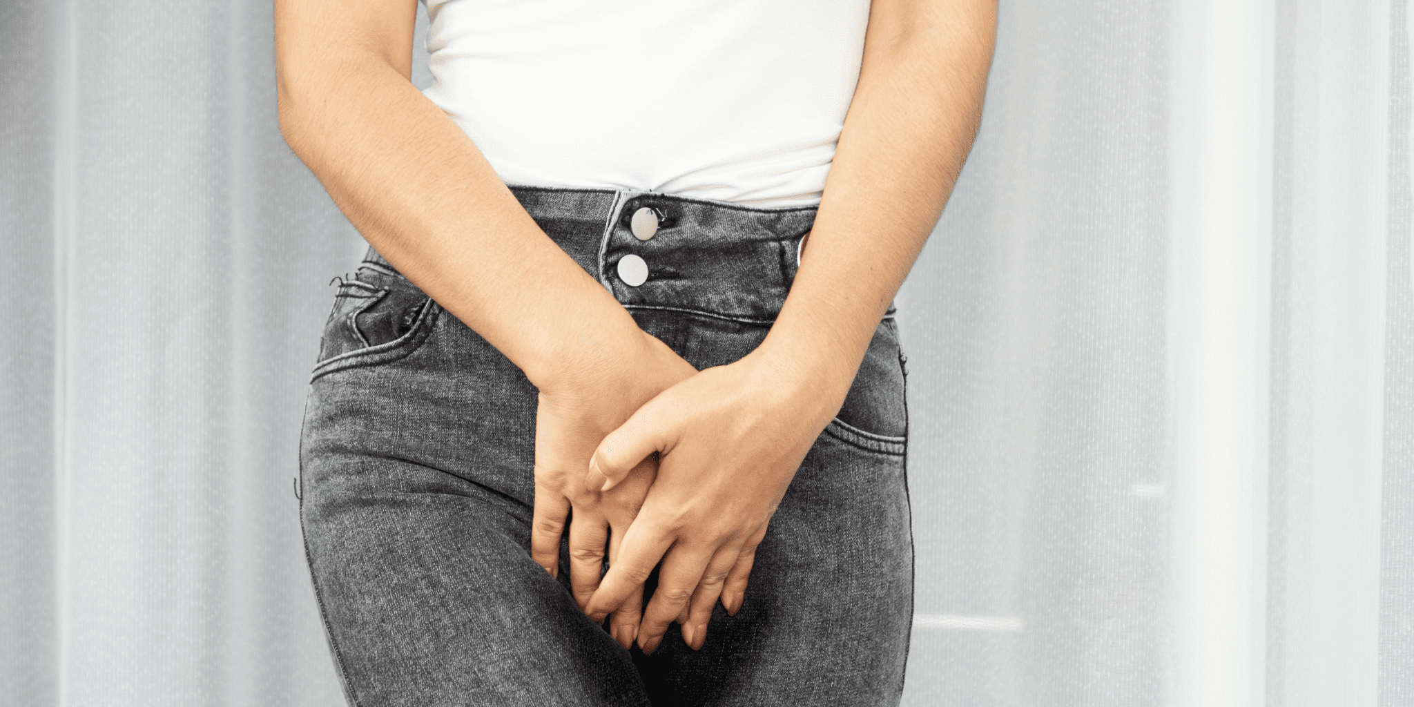 young woman in jeans holding bladder frequent urination