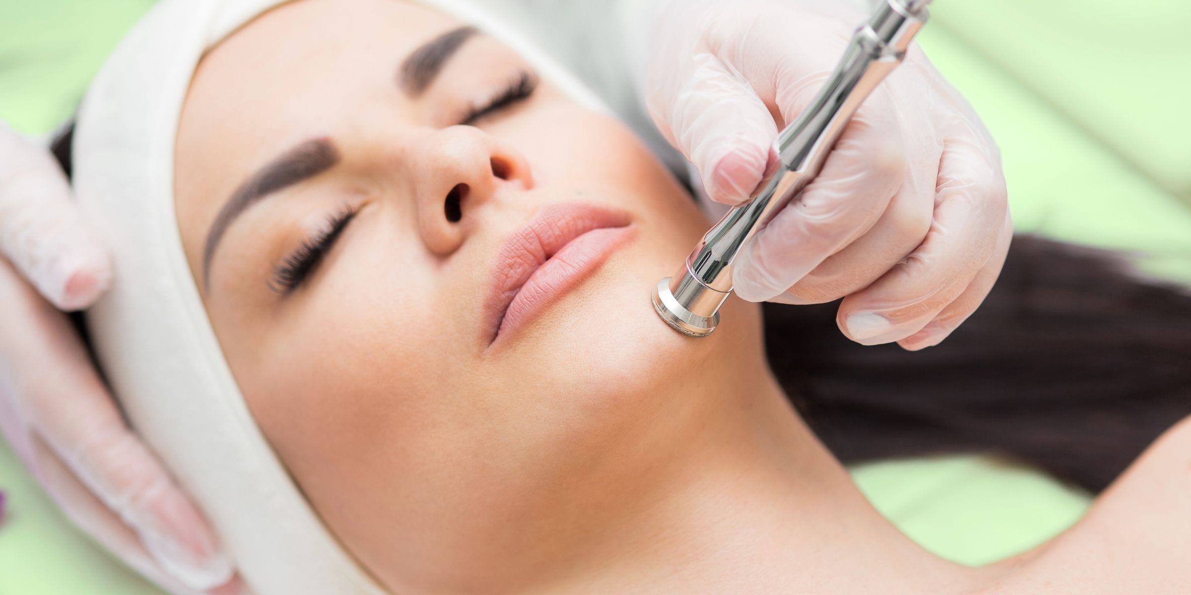 woman receiving facial to improve skin
