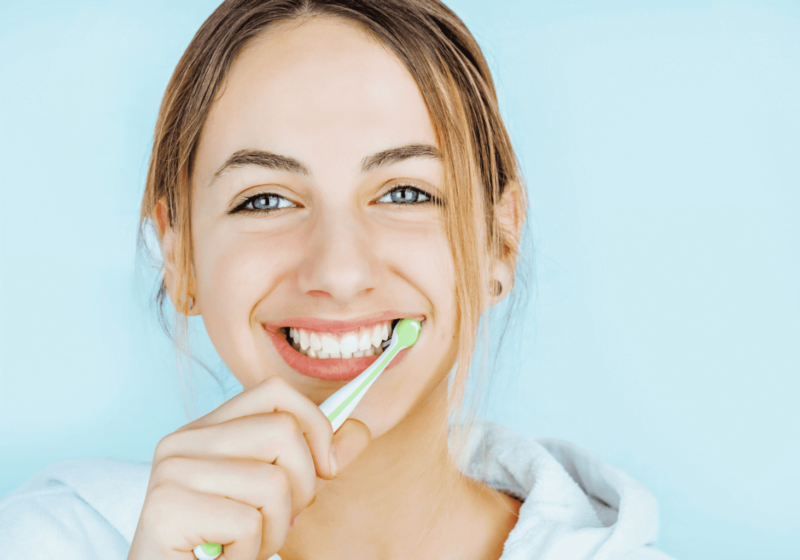 young woman brushing teeth healthy hygiene oral health