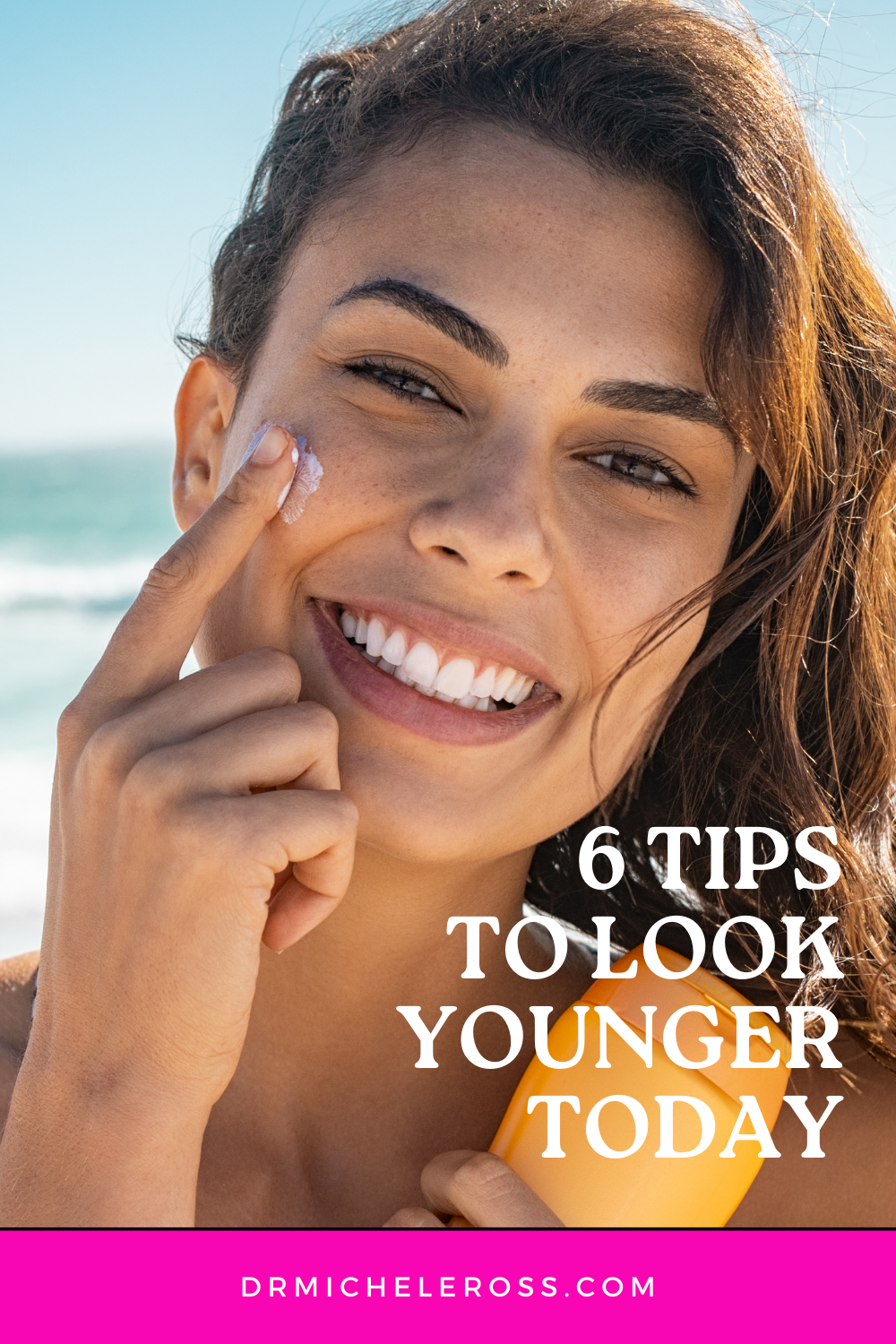 woman applying sunscreen at beach 6 tips to look younger pinterest