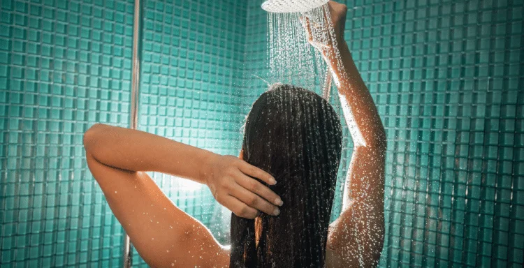 woman in blue green tile shower sobering up from weed
