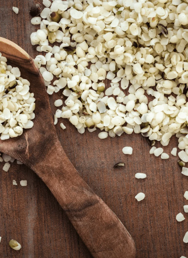 nutritious hemp seeds on counter with wooden spoon