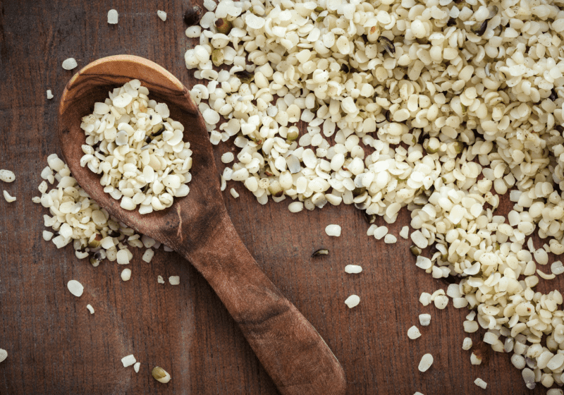 nutritious hemp seeds on counter with wooden spoon