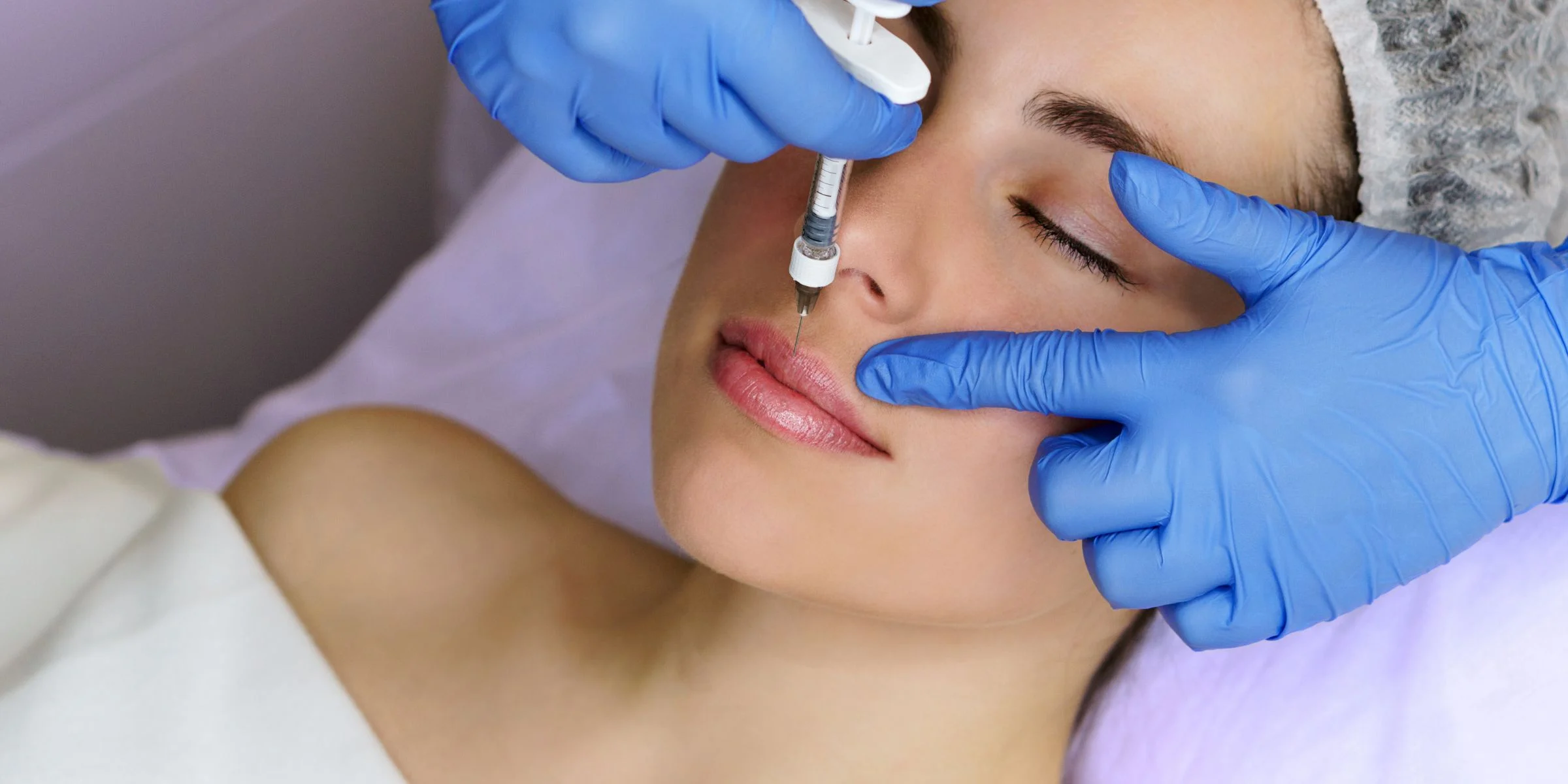 woman receiving lip filler injection cosmetic surgery to look better