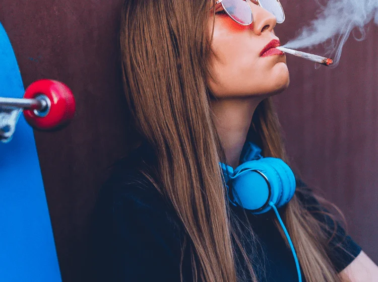 young woman smoking smelly weed joint