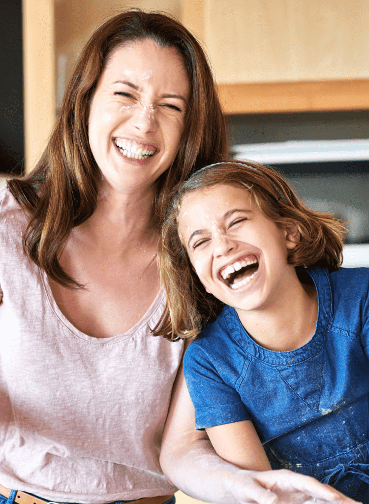 mom laughing with child looking younger managing stress well