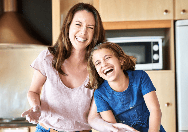 mom laughing with child looking younger managing stress well