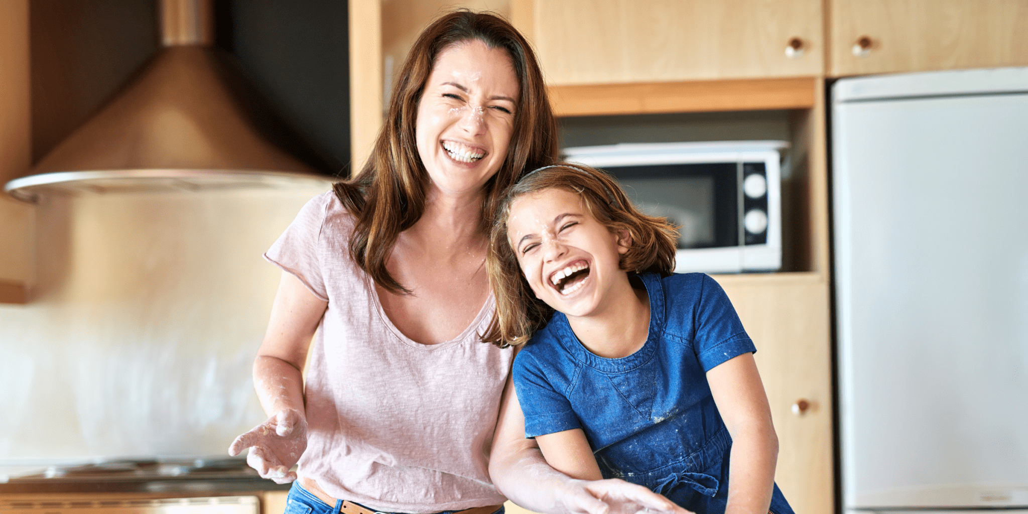 mom laughing with child looking younger managing stress well