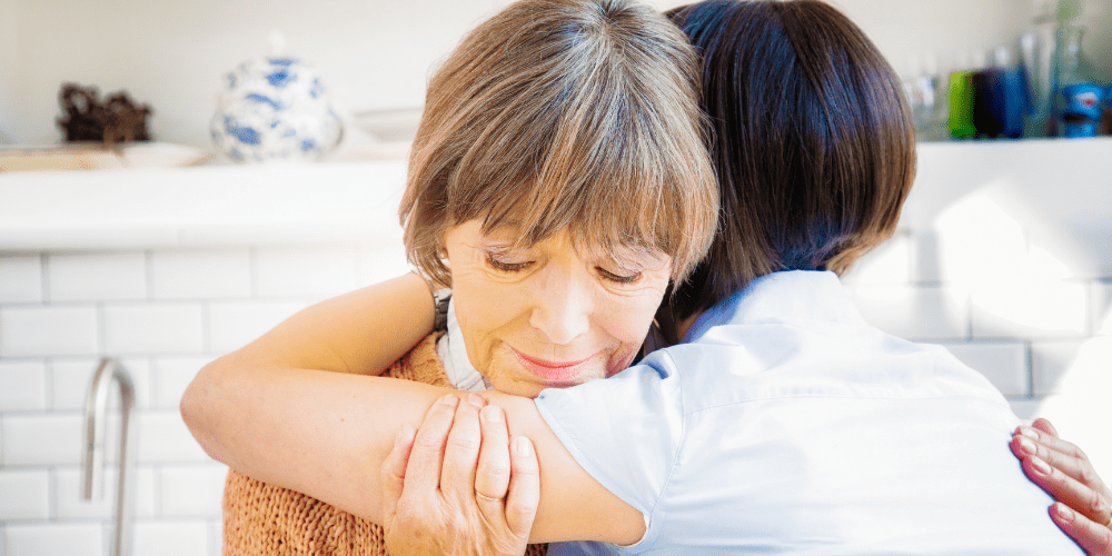 woman hugging mother with grief sad dad died