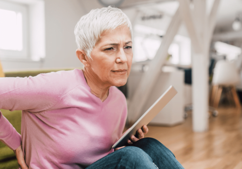 senior woman with arthritis in hands at doctor office