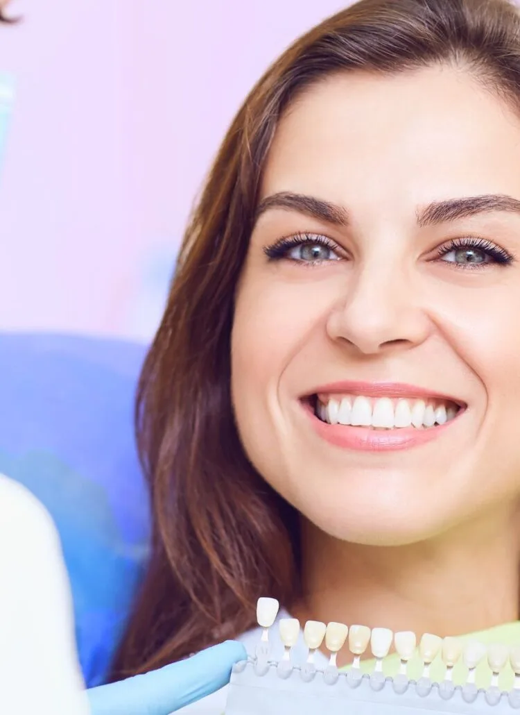 woman in dentist office smiling about to get dental implants