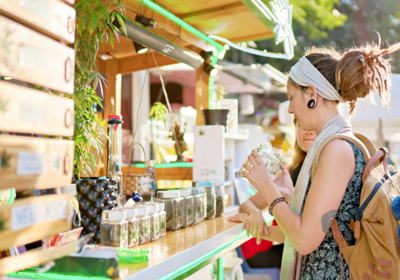 woman buying cannabis at a marijuana dispensary and outdoor weed market