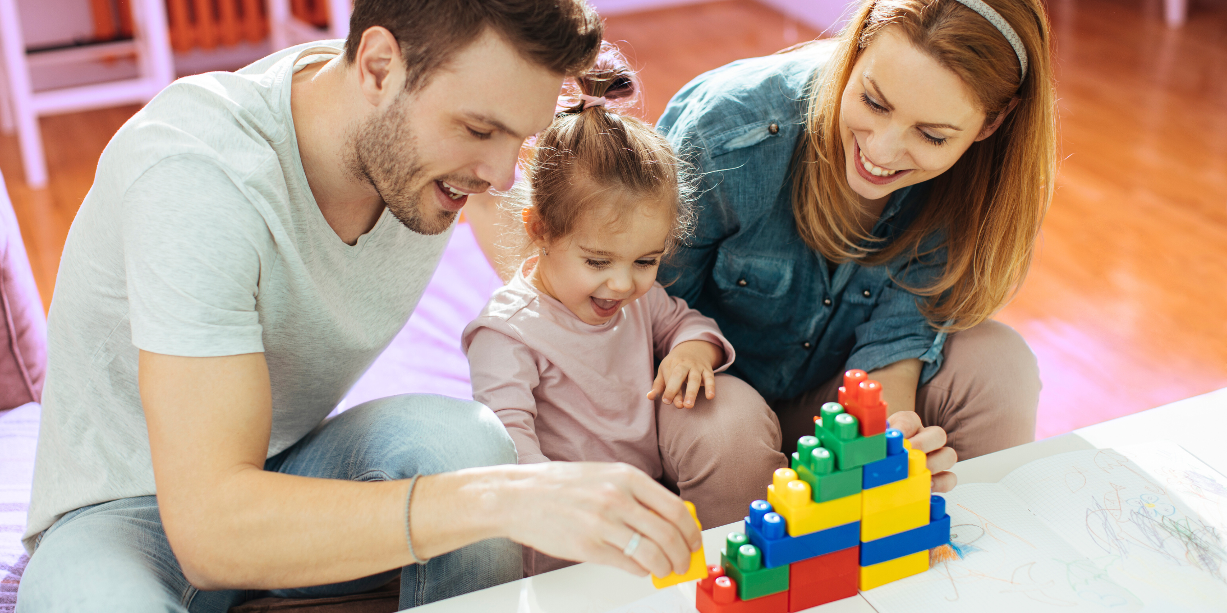 family playing legos with young daughter