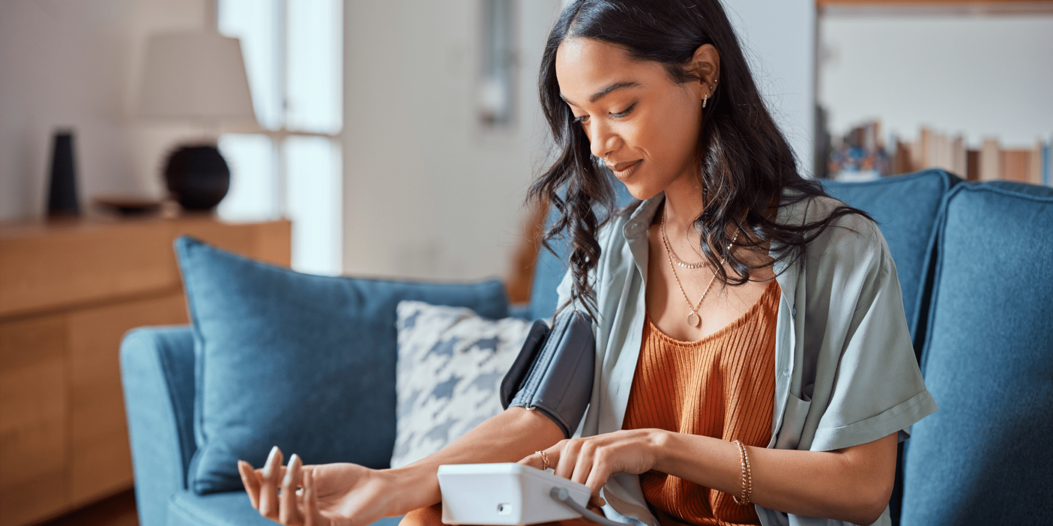 young woman checking blood pressure treating hypertension with CBD oil