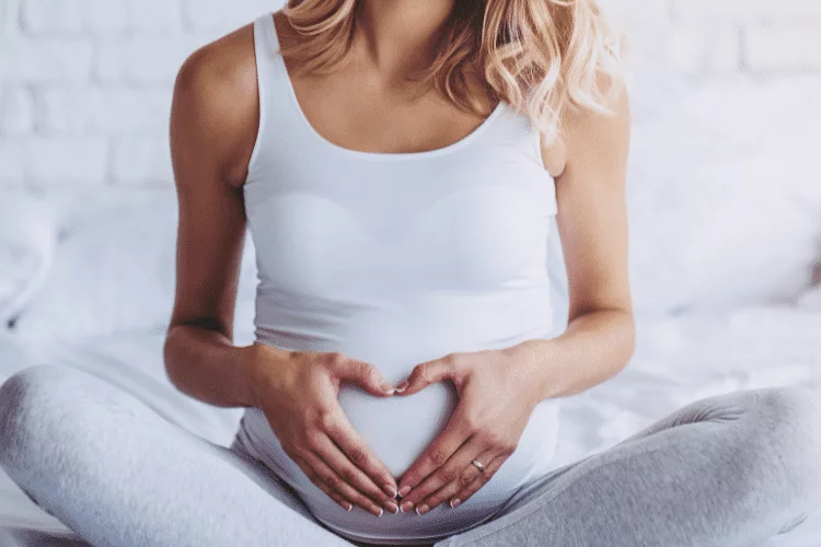 pregnant woman holding belly used CBD oil
