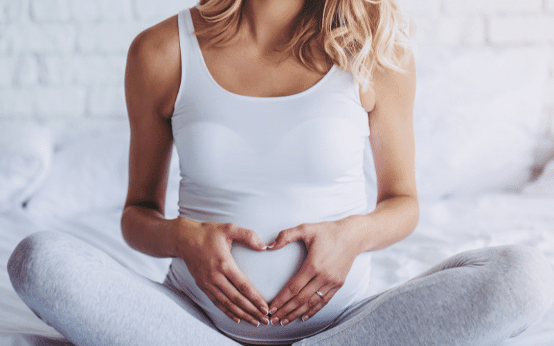 pregnant woman holding belly used CBD oil