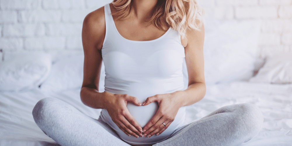 pregnant woman holding belly used CBD oil